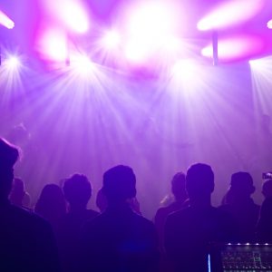 Rock band silhouettes on stage at concert.